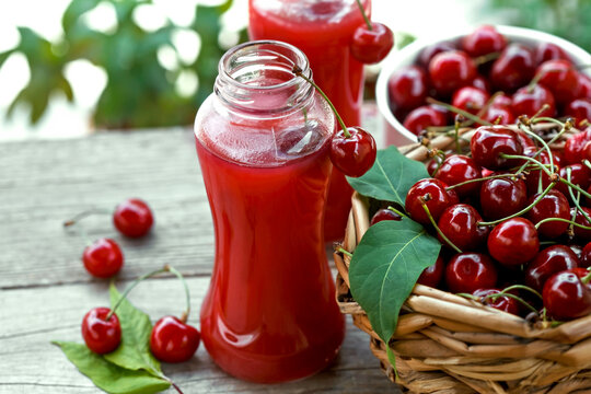 ripe cherries in a basket and fruit juice