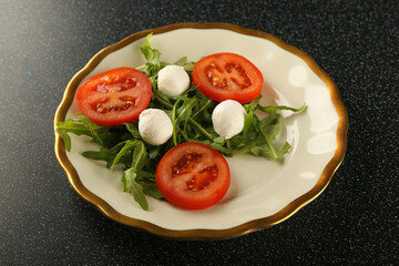 salad of tomatoes, herbs and mozzarella on a plate top view