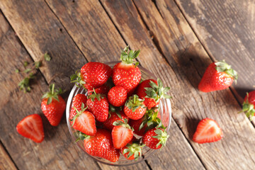 bowl of fresh strawberries on wood background