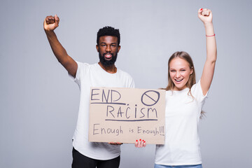 Young african man and coucasian woman holding a cardboard poster with the message text END RACISM isolated on white background, Concept on the theme of protest for police brutality and racism.