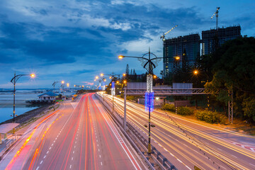 the light trails on the modern building background in malaysia.