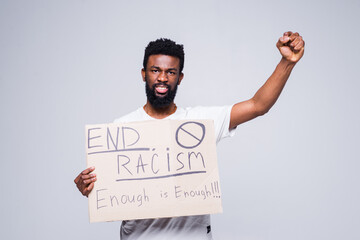 Young african man and coucasian woman holding a cardboard poster with the message text END RACISM...