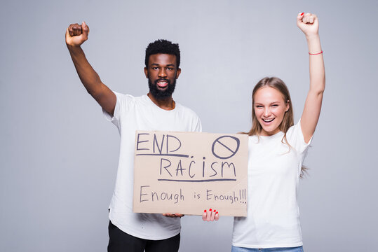 Young african man and coucasian woman holding a cardboard poster with the message text END RACISM isolated on white background, Concept on the theme of protest for police brutality and racism. - Powered by Adobe