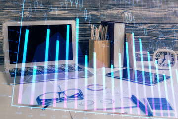 Double exposure of graph and financial info and work space with computer background. Concept of international online trading.