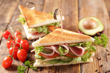 club sandwich with ham, tomato and lettuce