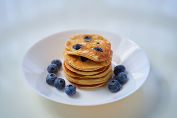 Blueberry Ricotta Pancakes on white wood background. toning. selective focus