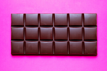 A large bar of chocolate on a bright background.