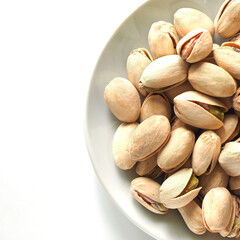 Pistachio nuts on a white surface.