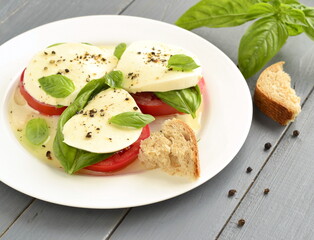 Caprese salad of tomato, mozzarella, basil. Italian food.