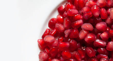Macro shot of delicious and healthy red pomegranate seeds - so called 