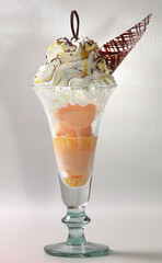 Exotic fruits in a glass with ice cream. Chocolate.