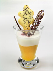 Exotic fruits in a glass with ice cream.