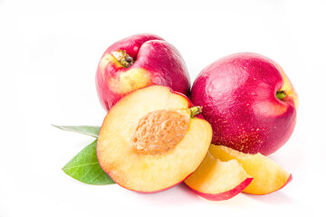Raw whole and half sliced peaches. Fresh summer peaches fruits isolated on white background