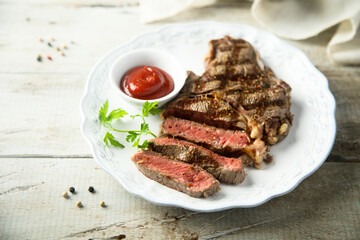 Grilled beef steak with tomato sauce