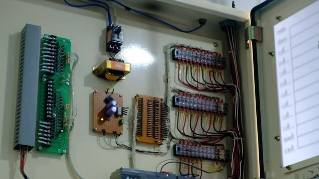 Wiring and electrical cabinet in industrial machine. Automatic Control Panel Cabinet with Buttons Wires Blocks. at an electrical substation.