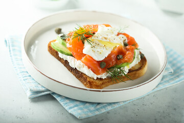 Poached egg with salmon and avocado on toast