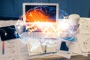 Multi exposure of work space with computer and human brain hologram. Brainstorm concept.