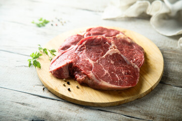 Raw beef steak on wooden desk