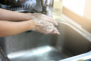 Fototapeta premium Washing hand in kitchen sink