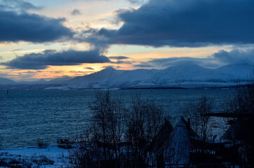 Fototapeta na wymiar colorful dawn sky over snowy mountain and sea