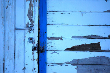 old weathered white and blue door with frame
