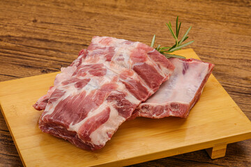 Raw pork ribs served rosemary