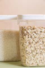 Plastic containers with cereals. Home storage products. Rice and oat.