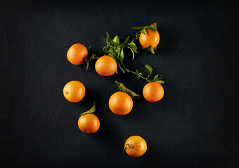 Mandarins with leaves on a dark background