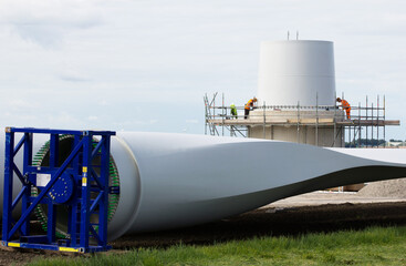 Construction workers busy with the foundation of a wind-turbine