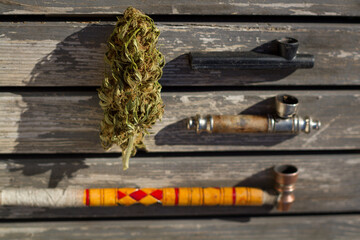 High angle view of smoking pipes with marijuana bud.