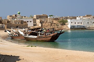 Fototapeta na wymiar View of Mirbat town, moored boats and Arabian sea. Oman. Asia. 