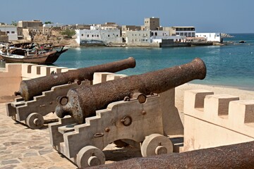 View of Mirbat town, moored boats and Arabian sea. Oman. Asia.
