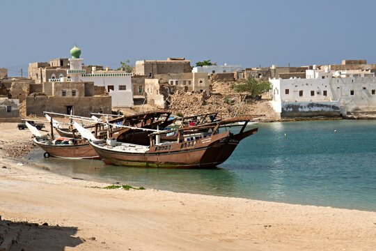 View of Mirbat town, moored boats and Arabian sea. Oman. Asia.
