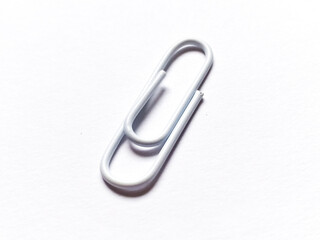 White paper clip on white background