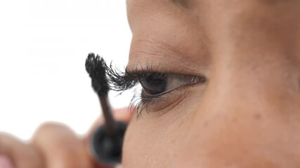 Close-up of a woman applying mascara on eyelashes. Beauty concept. Isolated, on white background - Powered by Adobe
