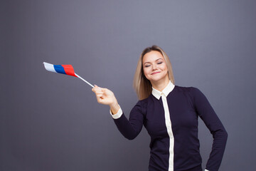 Immigration and the study of foreign languages, concept. A young smiling woman with a Russia flag...