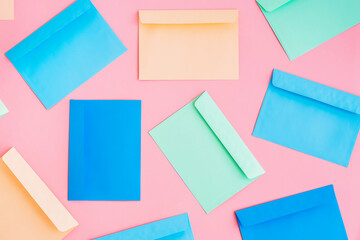 Pattern of colorful correspondence envelopes on pink background.