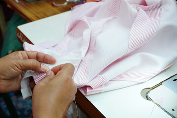 The seamstress works in his office.