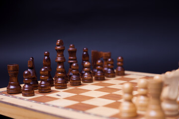 A game of chess, the beginning of a chess game two sides opposite each other.