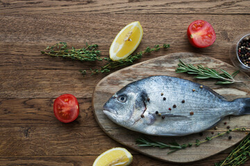 Fresh fish dorado. Dorado and ingredients for cooking.Top view with copy space.