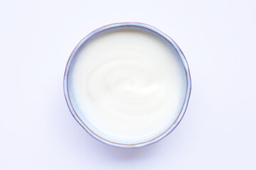 White yogurt in bowl on white background.
