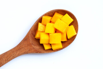 Tropical fruit, Mango cube slices on wooden spoon on white