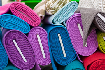 Colourful bales of fabric on a market