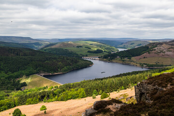 Naklejka premium Landscape of Ladybower reservoir shot from bamford edge crags looking down on to the road bridge in the peak district national park