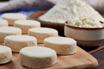 raw cottage cheese pancakes on the wooden board
