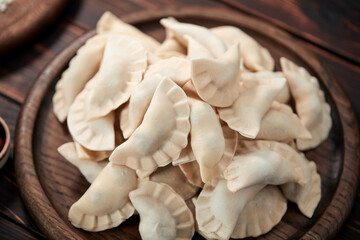 raw dumpling with cherries on the wooden board