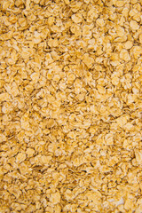 Oatmeal flakes scattered on a white background. Dietary food. Healthy breakfast.