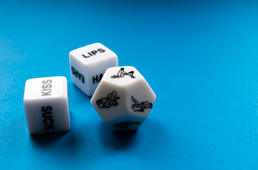 Three dice for sex games on a blue background