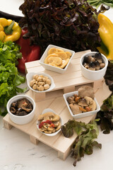 Composition of various mushrooms in oil in bamboo bowls. Preserves prepared at home as a side dish or appetizer typical of southern Italy in particular from Puglia