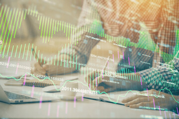 Multi exposure of forex chart with man working on computer on background. Concept of market analysis.